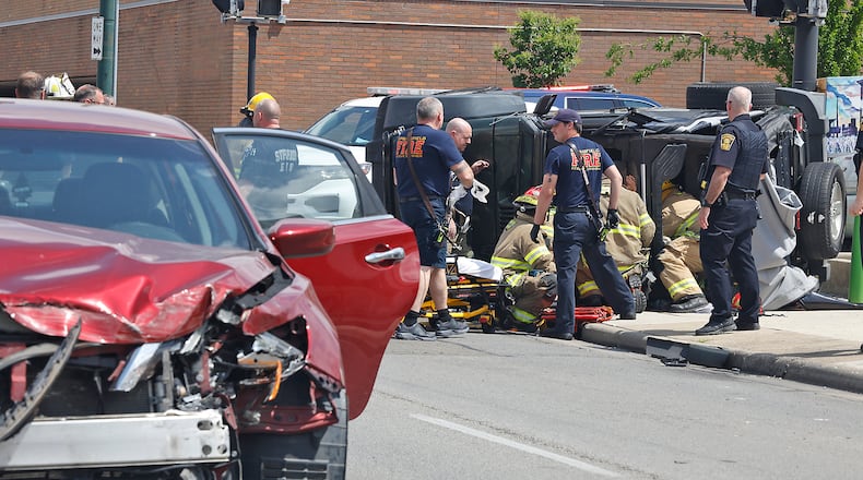 Two people had to be rescued from an overturned Jeep following a two car accident at the intersection of North Street and Fountain Avenue Monday, April 29, 2024. The two people in the Jeep were transported to the hospital with non-life threatening injuries. The driver of the other car was not injured. BILL LACKEY/STAFF