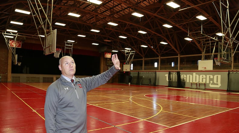 Wittenberg University Athletic Director Gary Williams talks about some of the improvements that will be made in the school’s Field House. Wittenberg was awarded $4.5 million in Ohio Historic Preservation Tax Credits to aid in the restoration of the historic field house built in 1929 and the construction of the Health, Wellness & Athletics Complex. Bill Lackey/Staff Wittenberg University Athletic Director Gary Williams looks over the bronze plaque on the school’s field house commemorating its construction in 1929. Wittenberg was awarded $4.5 million in Ohio Historic Preservation Tax Credits to aid in the restoration of the historic field house built in 1929 and the construction of the Health, Wellness & Athletics Complex. Bill Lackey/Staff