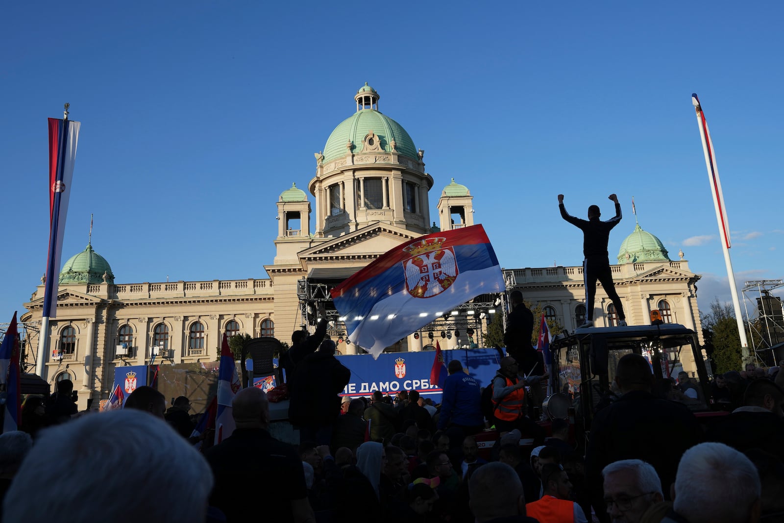Supporters of Serbia's President Aleksandar Vucic gather during a rally in his support, apparently designed to counter student-led gatherings, in Belgrade, Serbia, Saturday, April 12, 2025. (AP Photo/Darko Vojinovic)