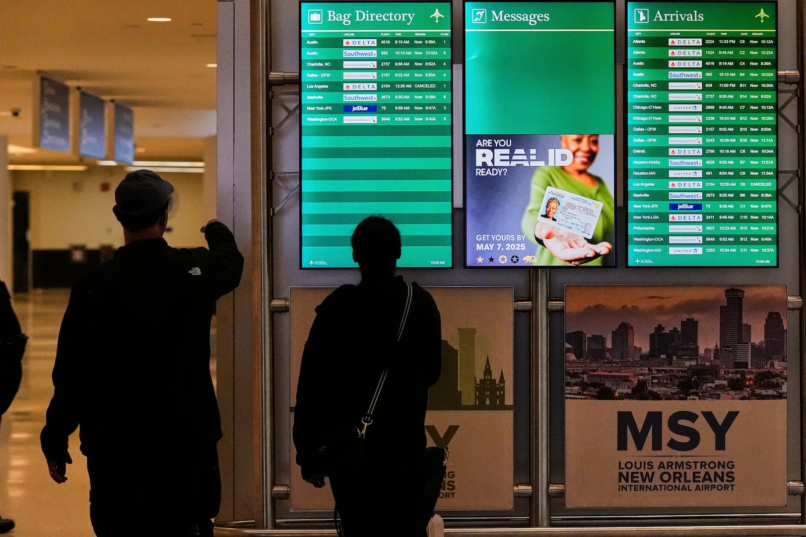 Signage reminds travelers of the new Real ID mandate at Louis Armstrong New Orleans International Airport in Kenner, La., the first day Real ID is implemented for commercial airline travel, Wednesday, May 7, 2025. (AP Photo/Gerald Herbert)