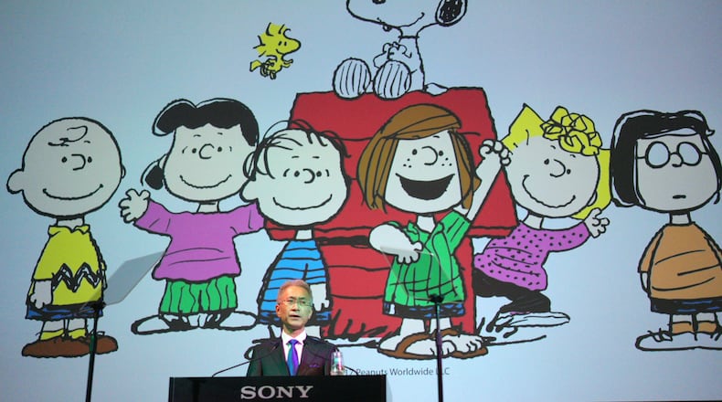 FILE - Sony Corp. President Kenichiro Yoshida speaks as characters from Peanuts are shown at a press conference at the company's headquarters Tuesday, May 22, 2018, in Tokyo. (AP Photo/Eugene Hoshiko, File)