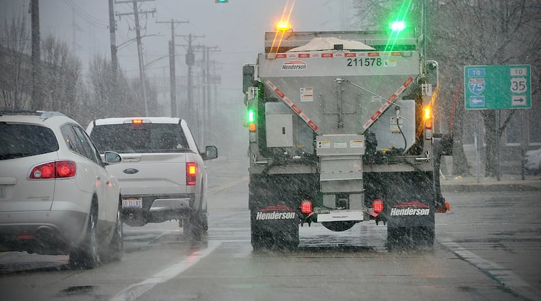Salt trucks were out working in downtown Dayton Friday, March 11, 2022, as snow started to fall. MARSHALL GORBY \STAFF