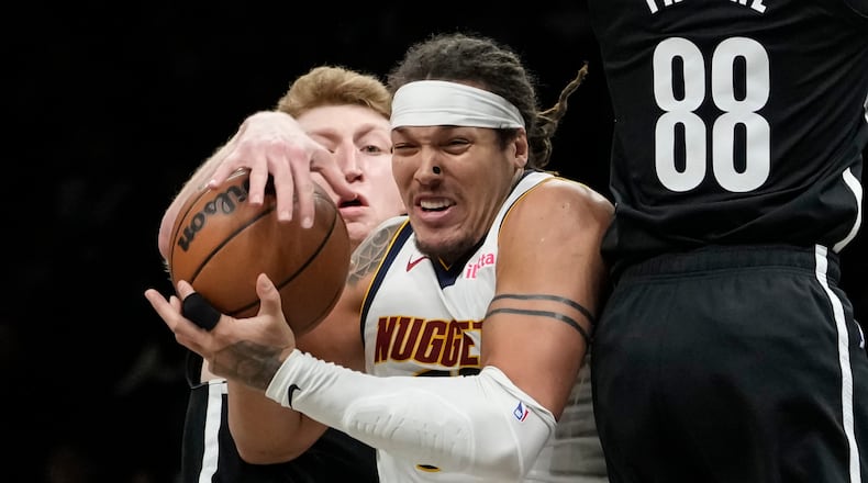Brooklyn Nets forward Danny Wolf, left, steals the ball from Denver Nuggets forward Aaron Gordon during the second half of an NBA basketball game, Sunday, Jan. 4, 2026, in New York. (AP Photo/Yuki Iwamura)