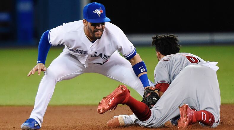 Cincinnati Reds’ Billy Hamilton (6) steals second base safely as Toronto Blue Jays second baseman Devon Travis (29) applies the tag during the seventh inning of an interleague baseball game in Toronto on Tuesday, May 30, 2017. (Nathan Denette/The Canadian Press via AP)