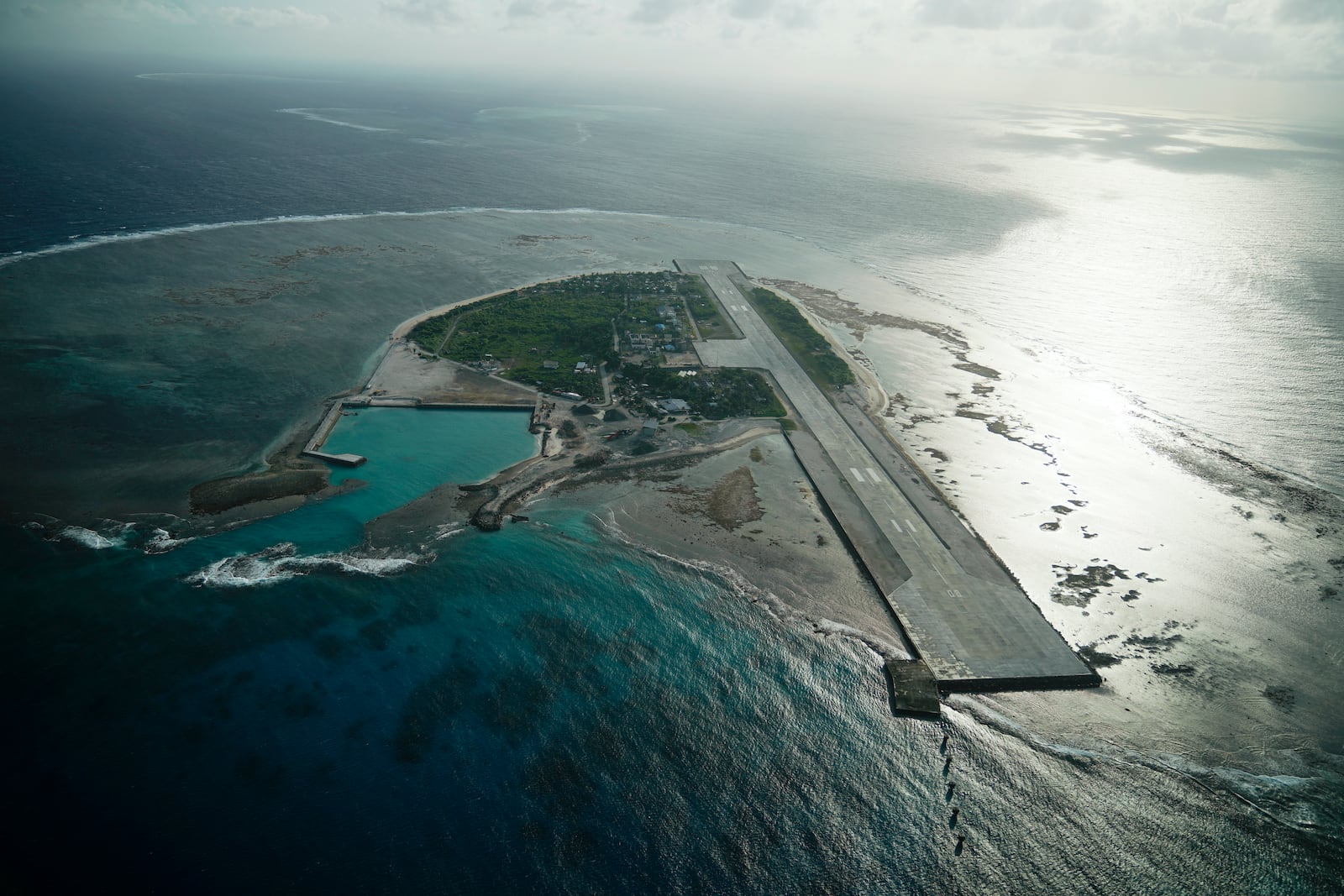 FILE - Philippine-occupied Thitu island, locally called Pag-asa island on Dec. 1, 2023, at the disputed South China Sea, is seen through an aircraft window. (AP Photo/Aaron Favila, File)