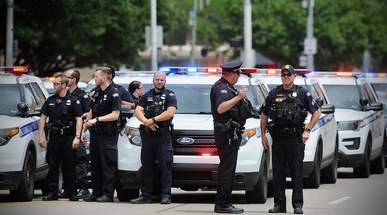 Dayton Police Department wait outside the Dayton Safety building Monday, July 25, 2022, to pay respects to fallen Clark County deputy Matthew Yates. A law enforcement procession escorted the body of the 15-year veteran from Dayton to Springfield. MARSHALL GORBY \STAFF
