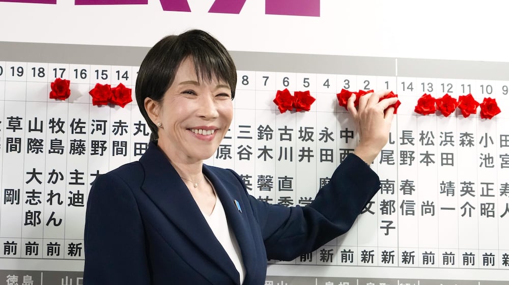Sanae Takaichi, Japan's prime minister and president of the ruling Liberal Democratic Party (LDP), puts pins marking the names of candidates who won lower house elections at the LDP headquarters Sunday, Feb. 8, 2026 in Tokyo. (Keisuke Hosojima/Kyodo News via AP)