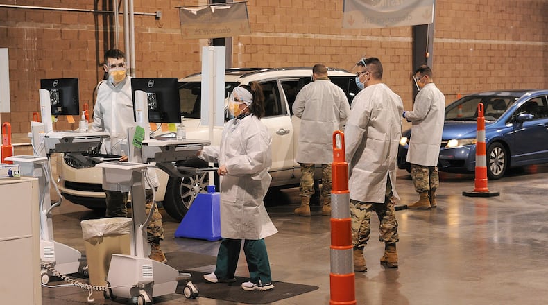 Vehicles line up at the Dayton Children's Springboro COVID-19 testing site Thursday Jan. 13, 2022. The Ohio National Guard is assisting with the testing allowing the site to triple its capacity. The facility, is located at 3300 W. Tech Road. MARSHALL GORBY\STAFF