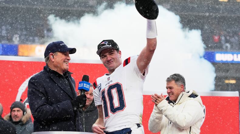 New England Patriots quarterback Drake Maye celebrates with the trophy after the AFC Championship NFL football game between the Denver Broncos and the New England Patriots, Sunday, Jan. 25, 2026, in Denver. (AP Photo/John Locher)