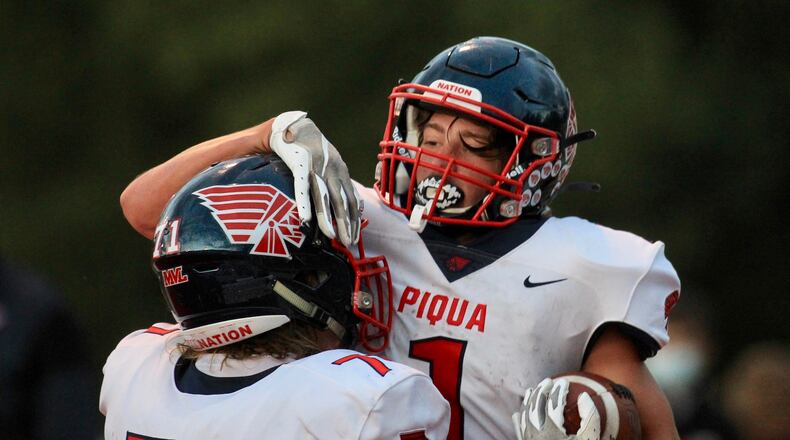 Piqua's Jacob Hepner and Tanner Kemp celebrate a touchdown run by Kemp against Tippecanoe on Friday, Sept. 25, 2020, in Tipp City. David Jablonski/Staff
