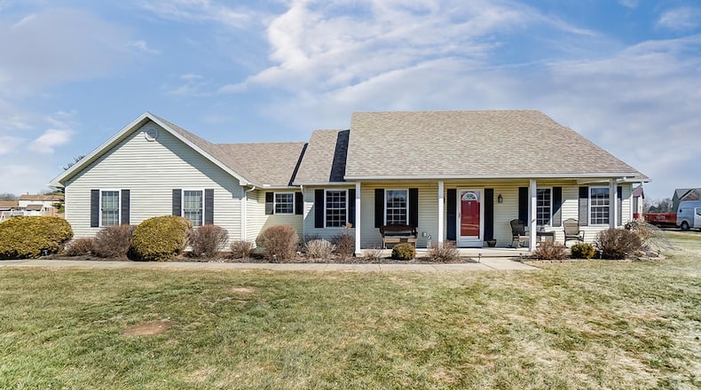 The 3-bedroom ranch with about 2,120 sq. ft. of living space features a concrete, covered porch and an attached, 2-car garage. CONTRIBUTED PHOTO