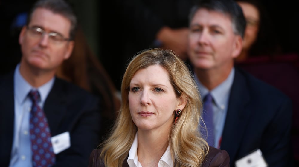 FILE - White House counsel Kathryn Ruemmler listens as President Barack Obama speaks at an installation ceremony for FBI Director James Comey at FBI Headquarters, in Washington, Oct. 28, 2013. (AP Photo/Charles Dharapak, File)