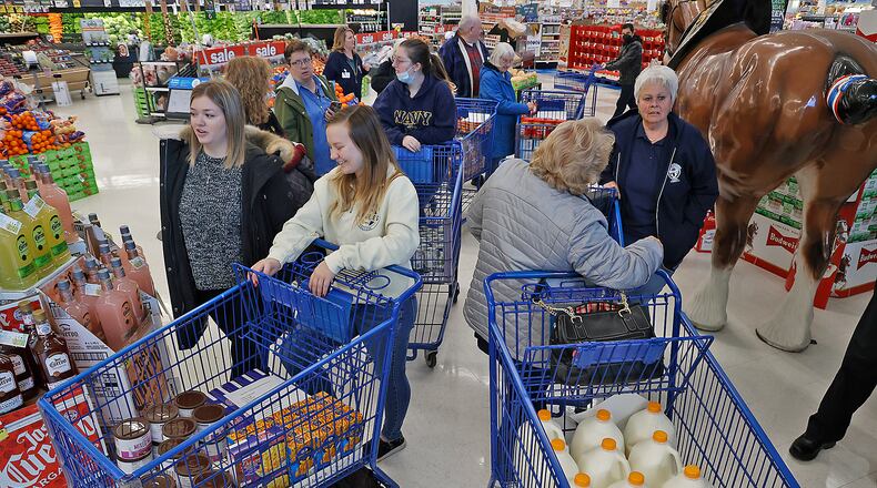 Operation Thanksgiving volunteers gather after collecting food at Meijer Tuesday, Nov. 22, 2022. BILL LACKEY/STAFF
