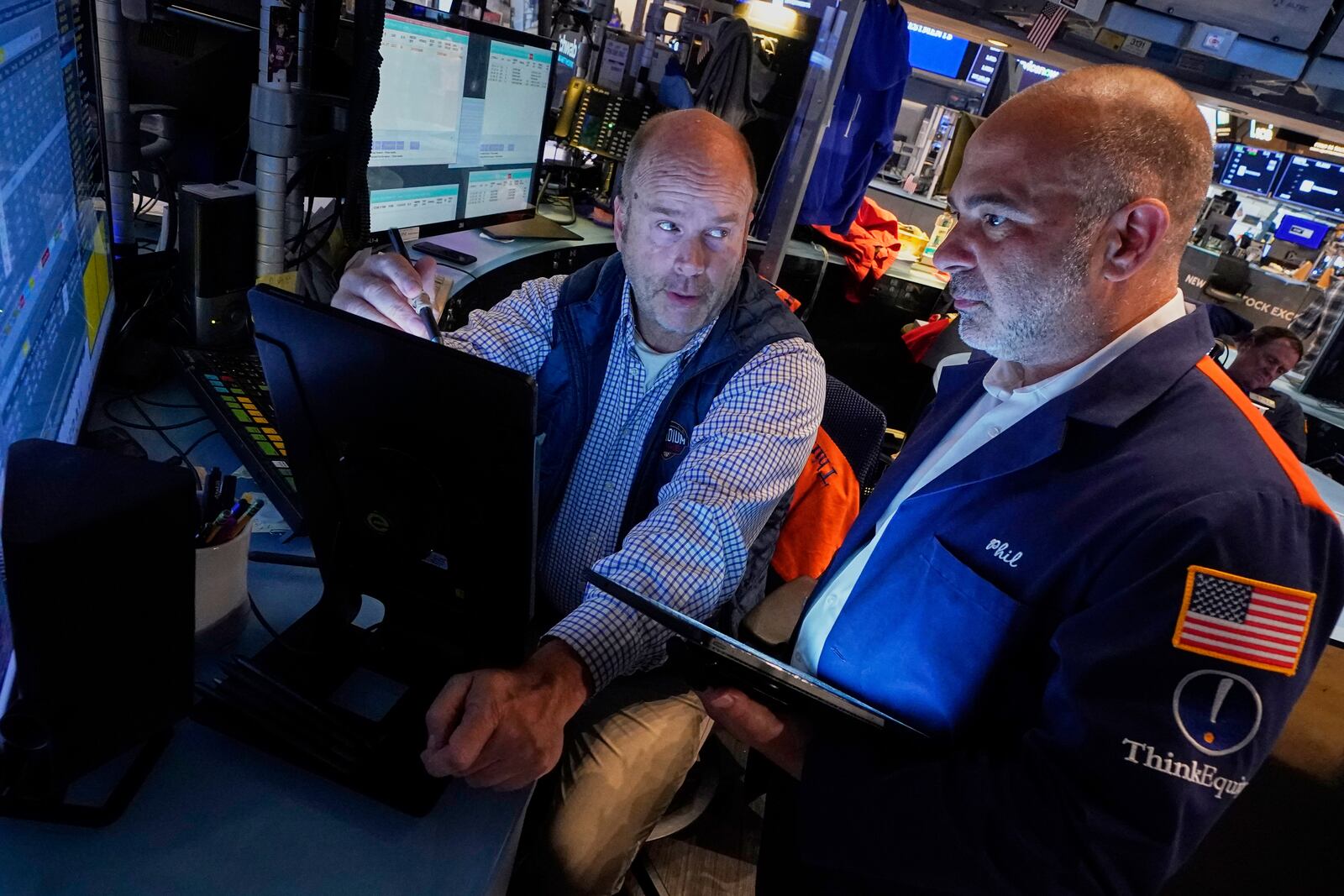Trades Peter Mancuso, left, and Phil Quartuccio work on the floor of the New York Stock Exchange, Friday, June 27, 2025. (AP Photo/Richard Drew)