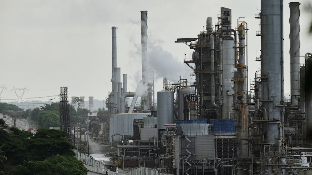 Vehicles drive past the El Palito refinery in Puerto Cabello, Venezuela, Sunday, Dec. 21, 2025. (AP Photo/Matias Delacroix)