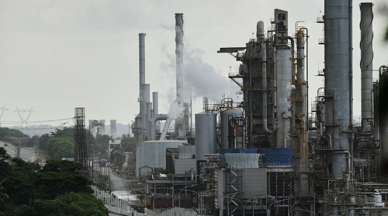Vehicles drive past the El Palito refinery in Puerto Cabello, Venezuela, Sunday, Dec. 21, 2025. (AP Photo/Matias Delacroix)