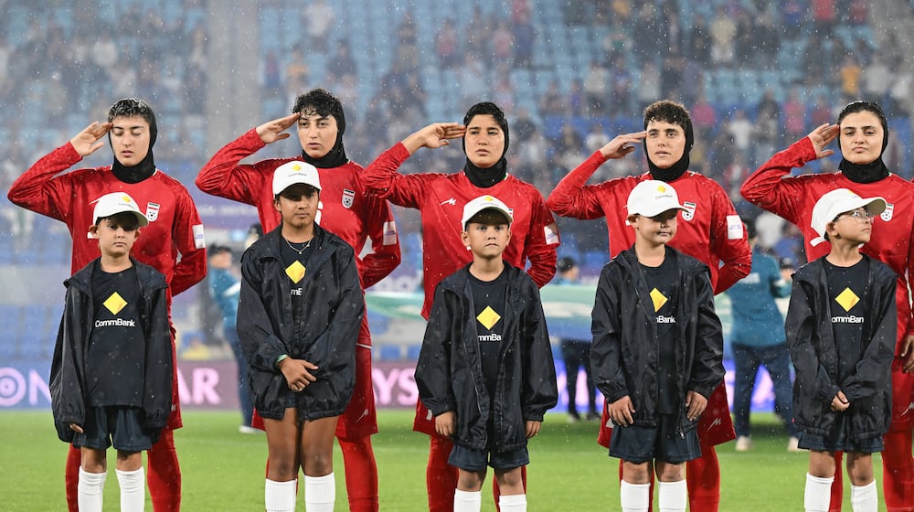 Iran players react during their national anthem ahead of the Women's Asian Cup soccer match between Iran and the Philippines in Robina, Australia, Sunday, March 8, 2026. (Dave Hunt/AAP Image via AP)