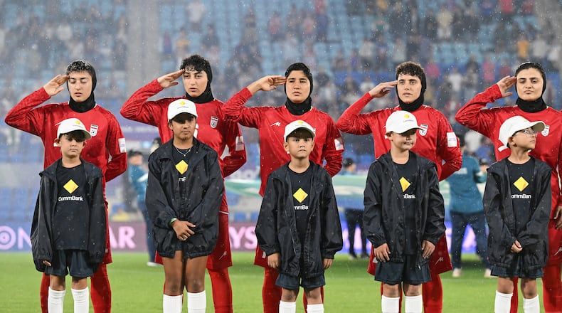 Iran players react during their national anthem ahead of the Women's Asian Cup soccer match between Iran and the Philippines in Robina, Australia, Sunday, March 8, 2026. (Dave Hunt/AAP Image via AP)