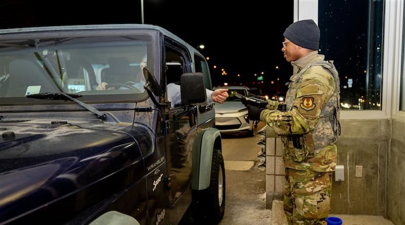 An airmen with the 88th Security Forces Squadron checks an identification card at Gate 15A at Wright-Patterson Air Force Base on Feb. 25, 2025. (Air Force photo by Jack Gardner)