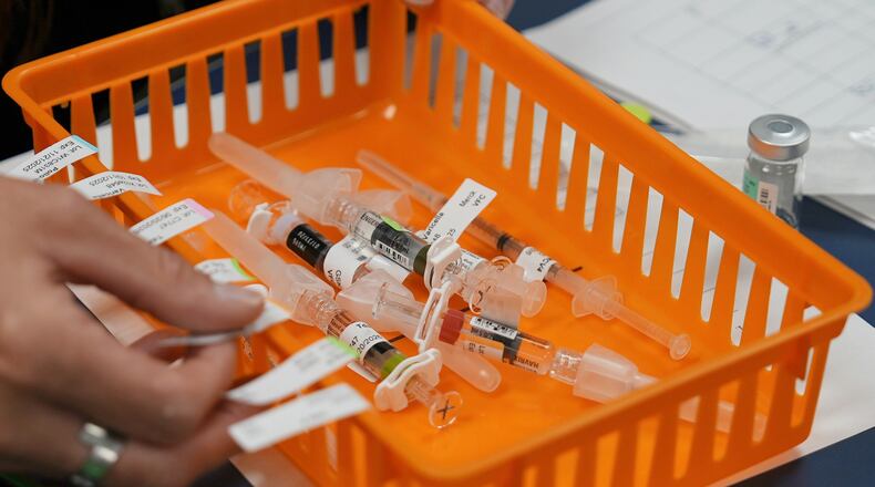 FILE - Vaccines are prepared for students during a pop-up immunization clinic at a school in Louisville, Ky., on Thursday, Aug. 8, 2024. (AP Photo/Mary Conlon, File)