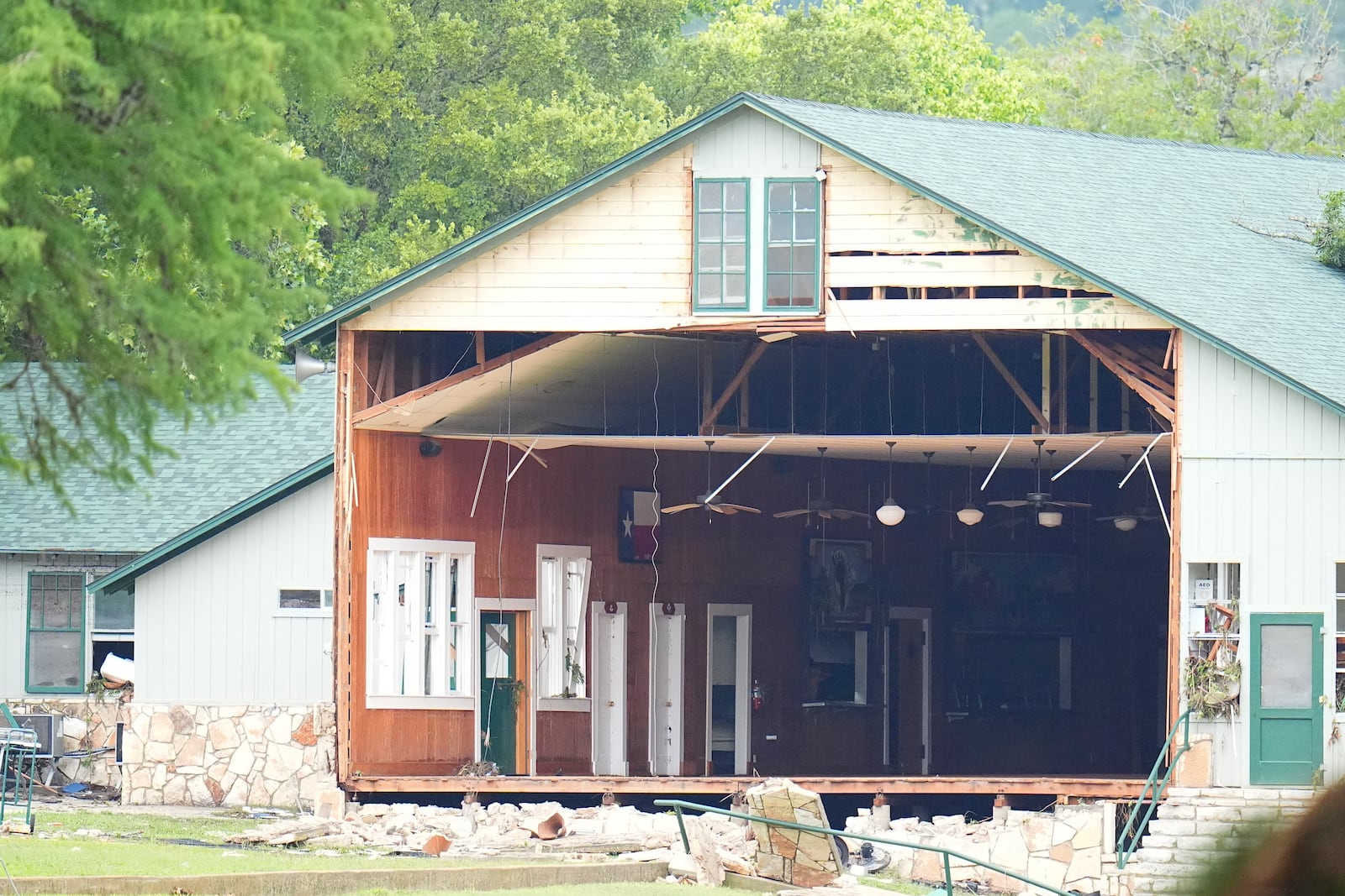 A wall is missing on a building at Camp Mystic along the banks of the Guadalupe River after a flash flood swept through the area Saturday, July 5, 2025, in Hunt, Texas. (AP Photo/Julio Cortez)