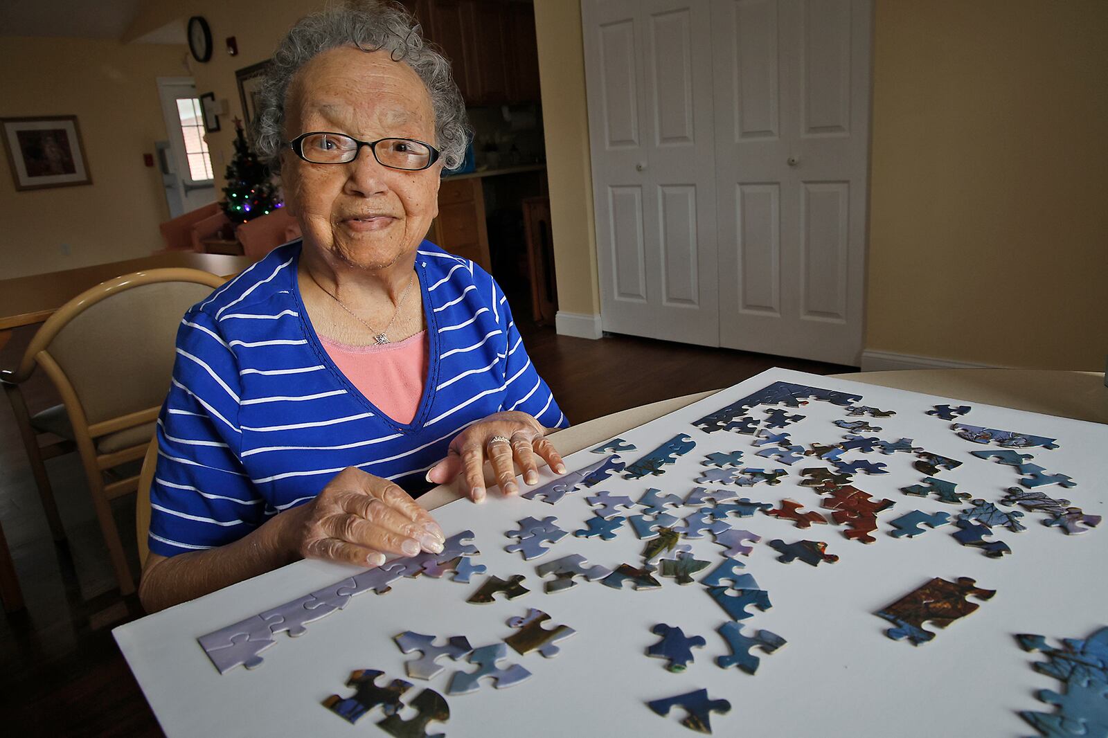 Clark Memorial Home resident, Anna Odessa Clayborne, works on a puzzle in the Activity Room Wednesday, Dec. 6, 2023. BILL LACKEY/STAFF