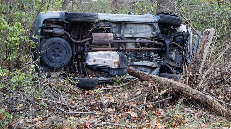 The driver of an SUV escaped a rollover crash on South Tecumseh Road without injury Wednesday, Nov. 1, 2023. The driver swerved to avoid a group of deer in the roadway when he lost control. The vehicle came to rest on its side, about 30 yards off the road. The driver got out of the SUV on his own. One deer was killed in the crash. BILL LACKEY/STAFF