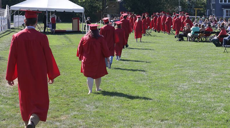 Southeastern High School had a semi-traditional commencement ceremony, with social distancing, in July on the schools football field. BILL LACKEY/STAFF