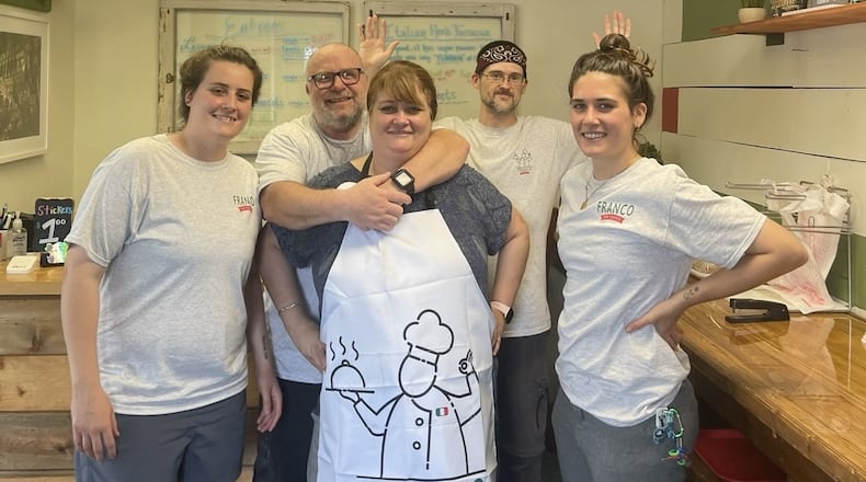 The Gallo family, (foreground, left to right) Alexa, Franco, Karen and Jess, in their family-owned New Carlisle restaurant, Franco the Foodie. Franco Gallo is in a Cincinnati hospital, and his family created a GoFundMe page for support while they hope for a second heart transplant. KAREN GALLO / CONTRIBUTED.