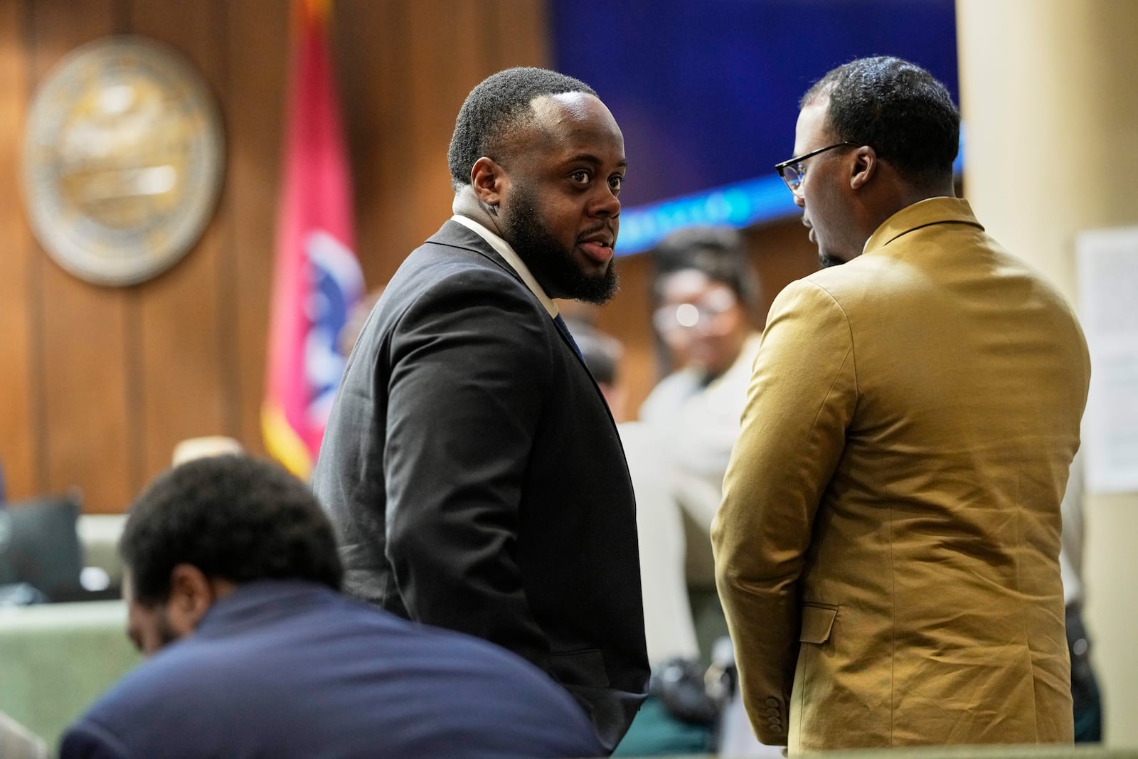 Former Memphis Police Officer Tedarrius Bean, center, one of three former Memphis officers charged with fatally beating Tyre Nichols in 2023, stands in the courtroom with his fellow defendants Justin Smith Jr., right, and Demetrius Haley, left, during break in the trial Wednesday, April 30, 2025, in Memphis, Tenn. (AP Photo/George Walker IV, Pool)