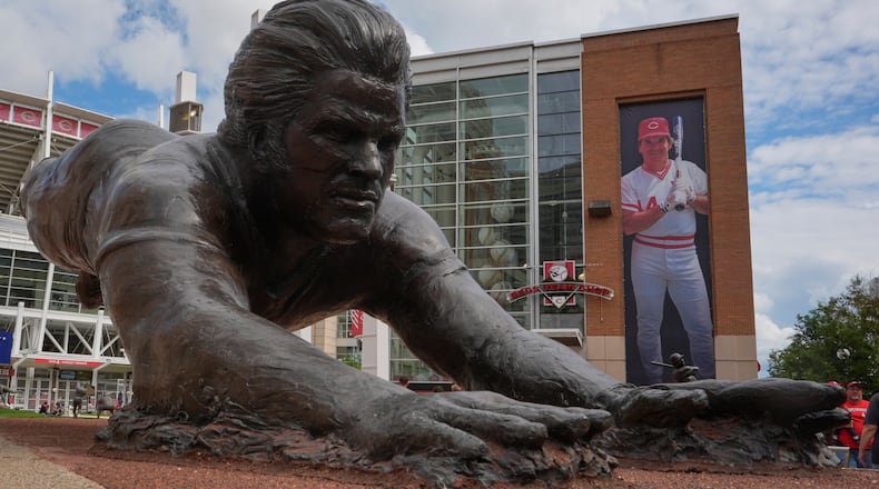A bronze statue and a banner of former Cincinnati Reds player Pete Rose are seen outside the Great American Ball Park, Tuesday, May 13, 2025, in Cincinnati. (AP Photo/Carolyn Kaster)
