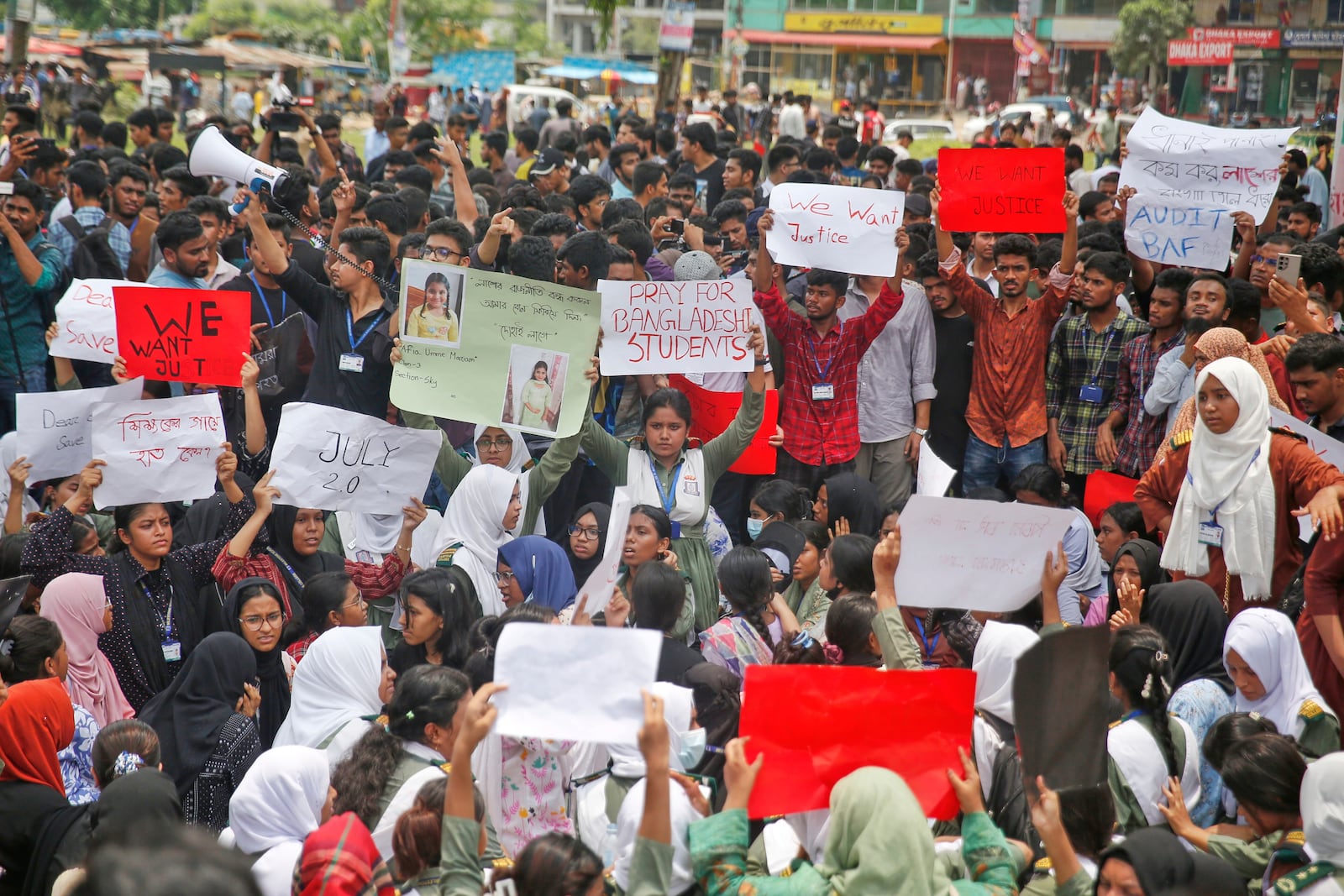 Students shout slogans during a protest near the site of the Monday crash of a Bangladesh air force training jet into a school, demanding accountability, compensation for victims' families and the halt of training flights, in Dhaka, Bangladesh, Tuesday, July 22, 2025. (AP Photo/ Mehedi Hasan)