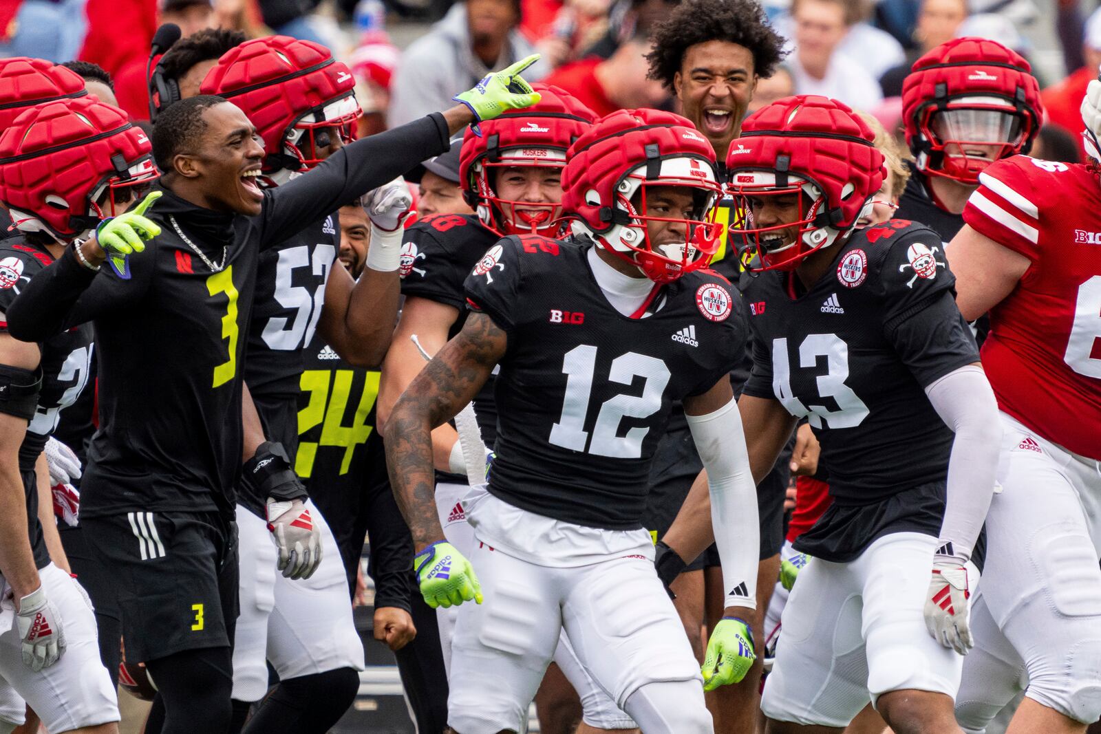 Nebraska defensive back Kahmir Prescott (12) celebrates with teammates after an interception during an NCAA college football practice Saturday, April 26, 2025, in Lincoln, Neb. (AP Photo/Dylan Widger)