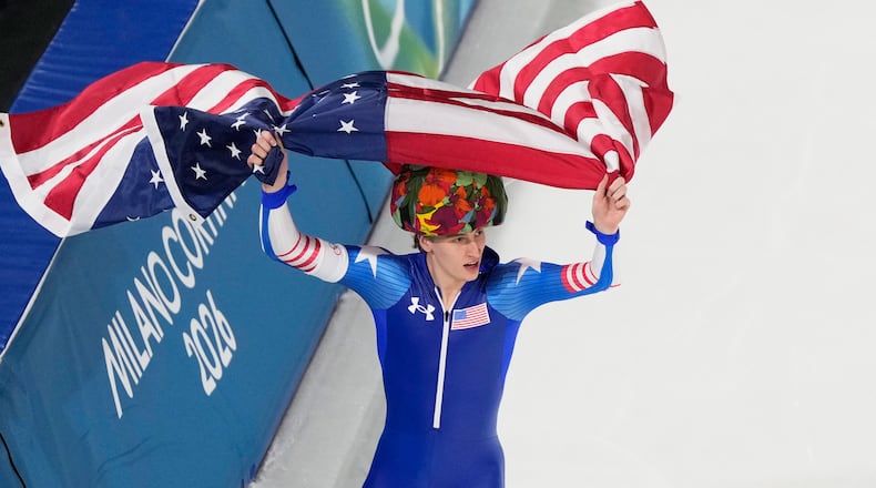 United States' Jordan Stolz celebrates after winning gold and setting a new Olympic record in the men's 500-meters speedskating final at the 2026 Winter Olympics, in Milan, Italy, Saturday, Feb. 14, 2026. (AP Photo/David J. Phillip)