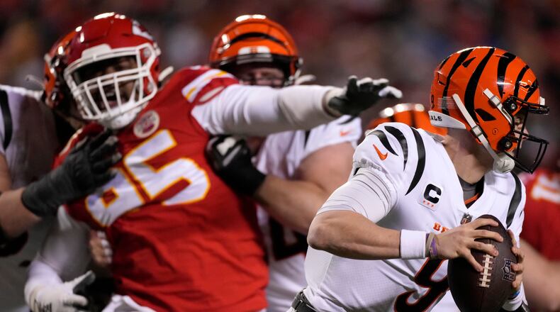 Cincinnati Bengals quarterback Joe Burrow (9) runs from Kansas City Chiefs defensive tackle Chris Jones (95) during the second half of the NFL AFC Championship playoff football game, Sunday, Jan. 29, 2023, in Kansas City, Mo. (AP Photo/Jeff Roberson)