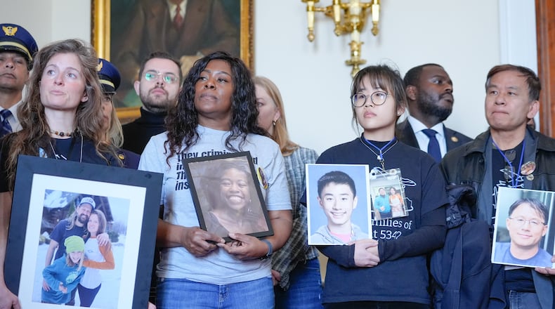 Family members of the people who were killed in the midair collision near Washington Reagan National Airport listen during a news conference as Rep. Don Beyer, D-Va., speaks, not shown, on Capitol Hill, Tuesday, Feb. 24, 2026, in Washington. (AP Photo/Mariam Zuhaib)