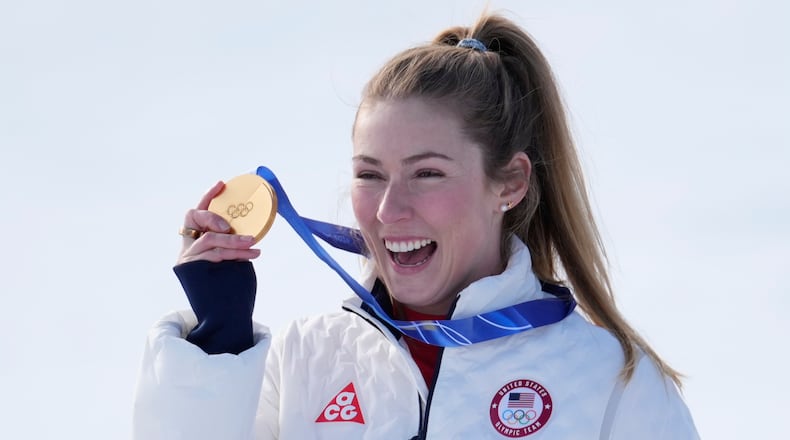 United States' Mikaela Shiffrin shows her gold medal of the alpine ski, women's slalom race, at the 2026 Winter Olympics, in Cortina d'Ampezzo, Italy, Wednesday, Feb. 18, 2026. (AP Photo/Robert F. Bukaty)