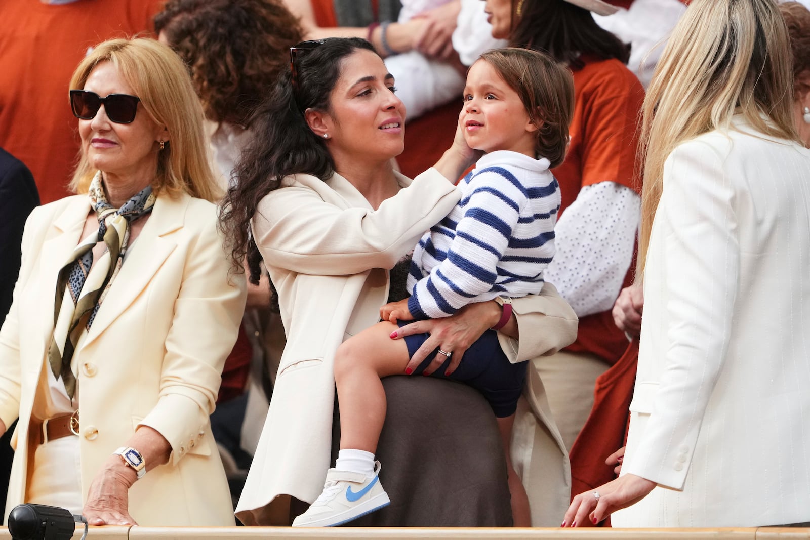 Rafa Nadal's wife, Maria Francisca Perello, holds her son Rafael Junior, during a farewell ceremony at center court Philippe-Chatrier, at the Roland-Garros stadium, in Paris, Sunday May 25, 2025. (AP Photo/Lindsey Wasson)