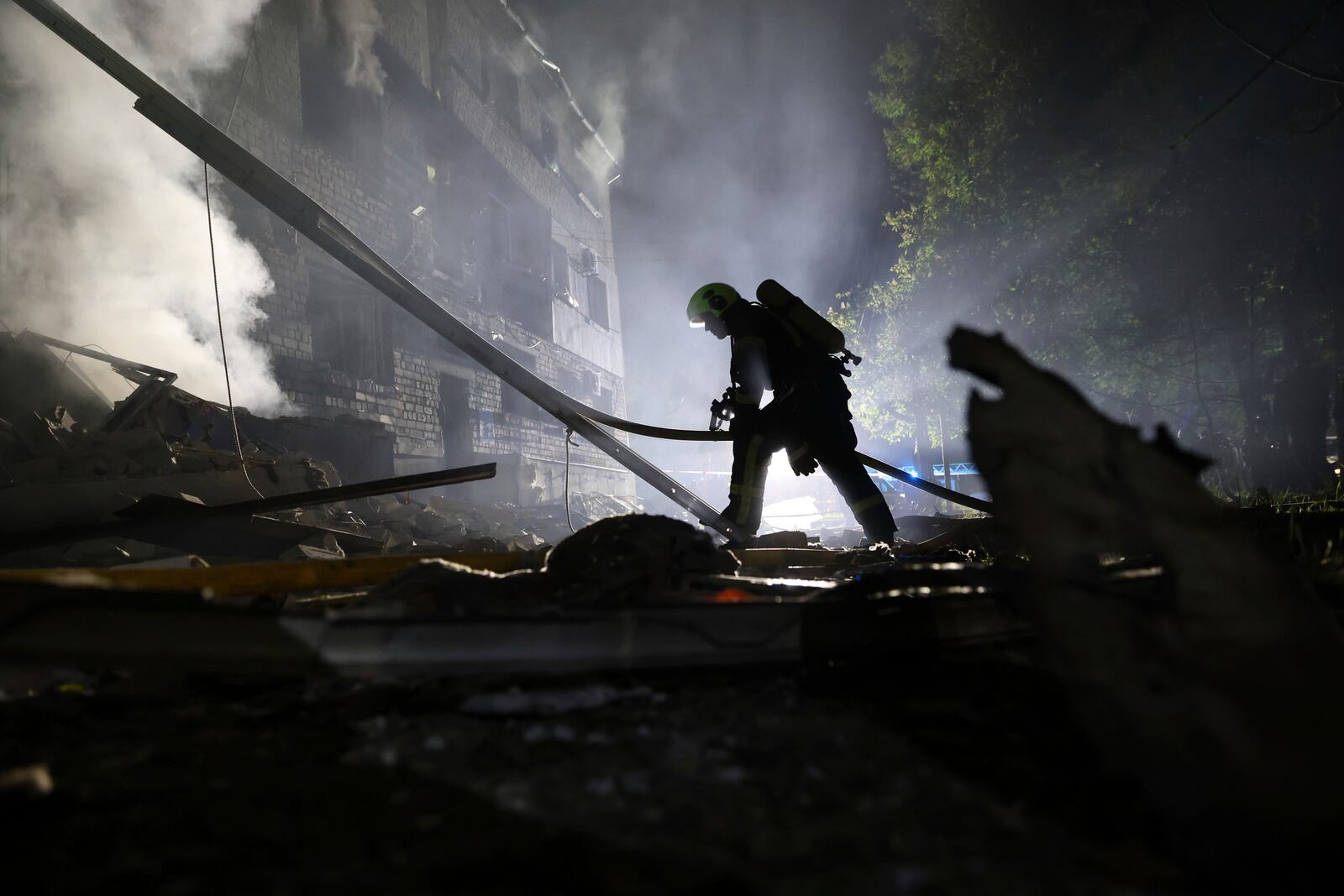 A rescuer works on a site of a residential building destroyed by a Russian strike in Zaporizhzhia, Ukraine, Thursday, May 1, 2025. (AP Photo/Kateryna Klochko)