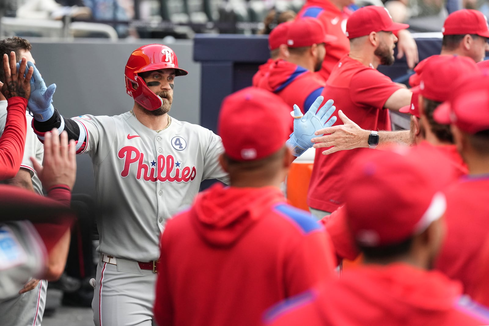 Philadelphia Phillies' Bryce Harper (3) celebrates in the dugout after hitting a solo home run off Toronto Blue Jays pitcher Bowden Francis during the first inning of a baseball game in Toronto, Tuesday June 3, 2025. (Chris Young/The Canadian Press via AP)
