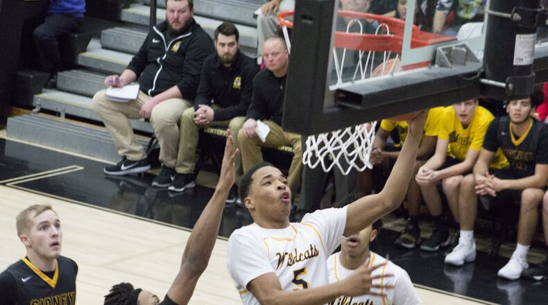Springfield’s Raheim Moss scores over Sidney’s Ratez Roberts during Friday night’s sectional final at Centerville High School. Jeff Gilbert/CONTRIBUTED