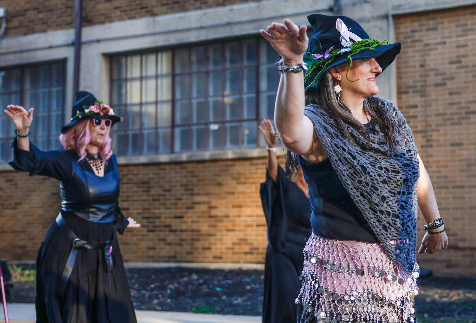 Bonnie Martens, right, dances with the Rose City Witches outside Myers Market on Friday, October 3, 2025, in Springfield. The performance was part of a Think Pink Foundation event to raise awareness about breast cancer. JOSEPH COOKE/STAFF