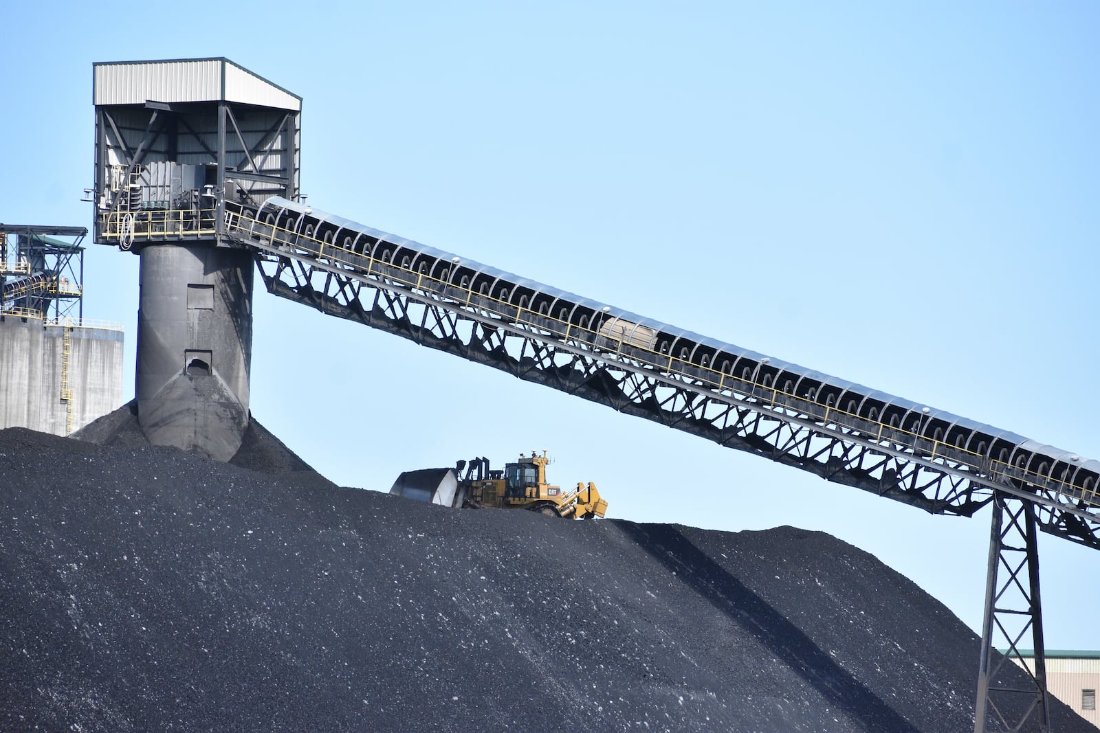 A heavy machinery operator is seen moving coal at Signal Peak Energy's Bull Mountains Mine, on May 21, 2025, near Roundup, Montana. (AP Photo/Matthew Brown)