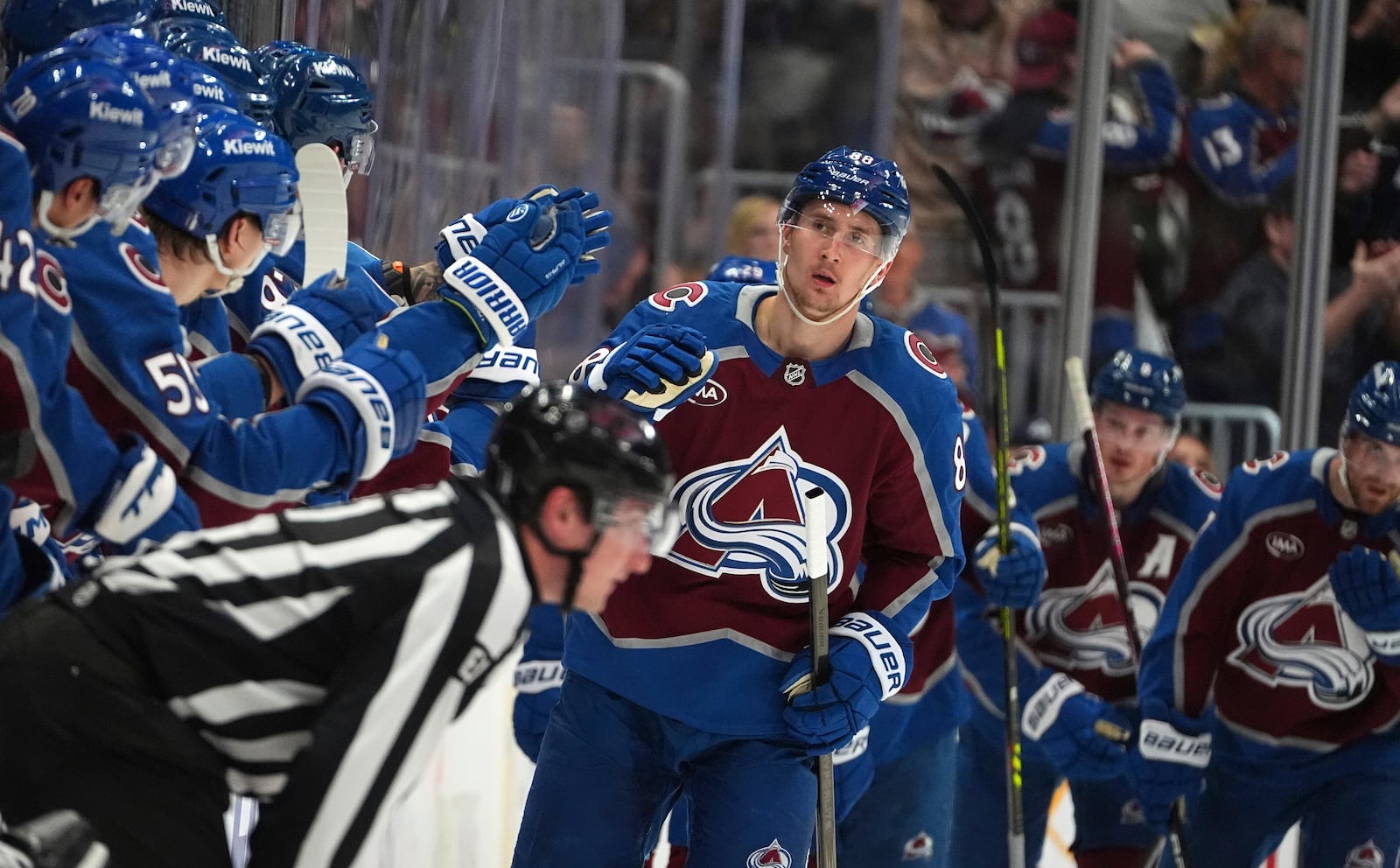 Colorado Avalanche center Martin Necas, center, is congratulated as he passes the team box after scoring in the second period of Game 6 of an NHL hockey first-round playoff series against the Colorado Avalanche, Thursday, May 1, 2025, in Denver. (AP Photo/David Zalubowski)