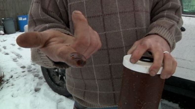 Brian Moore holds a friend’s water filter from a house in Christiansburg. Moore says the filter is supposed to be good for six month, but is already brimming with residue after only a month and a half. JENNA LAWSON/STAFF.
