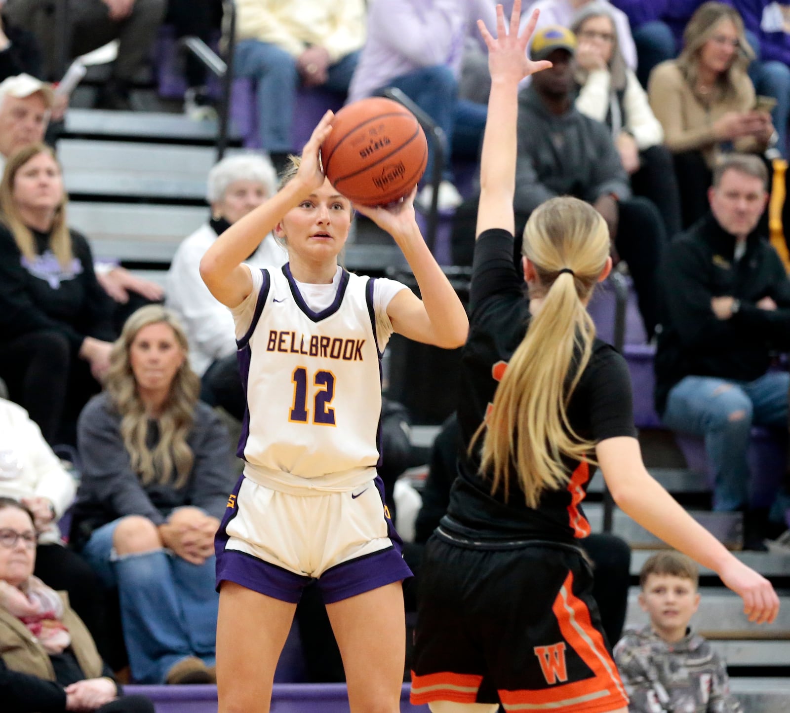Bellbrook junior Lauren Fabrick pump fakes a shot as Waynesville senior Katie Berrey closes in. Bellbrook defeated Waynesville 61-30 in a Southwestern Buckeye League crossover game on Thursday, Feb. 12, 2026. STEVEN WRIGHT / STAFF