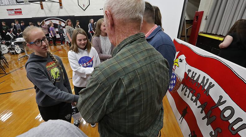 Greenon students shake hands with veterans and thank them for their service at the conclusion of the Greenon Veteran’s Day Program Monday. BILL LACKEY/STAFF