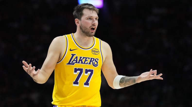 Los Angeles Lakers guard Luka Doncic (77) argues a call during the second half of an NBA basketball game against the Miami Heat, Thursday, March 19, 2026, in Miami. (AP Photo/Lynne Sladky)