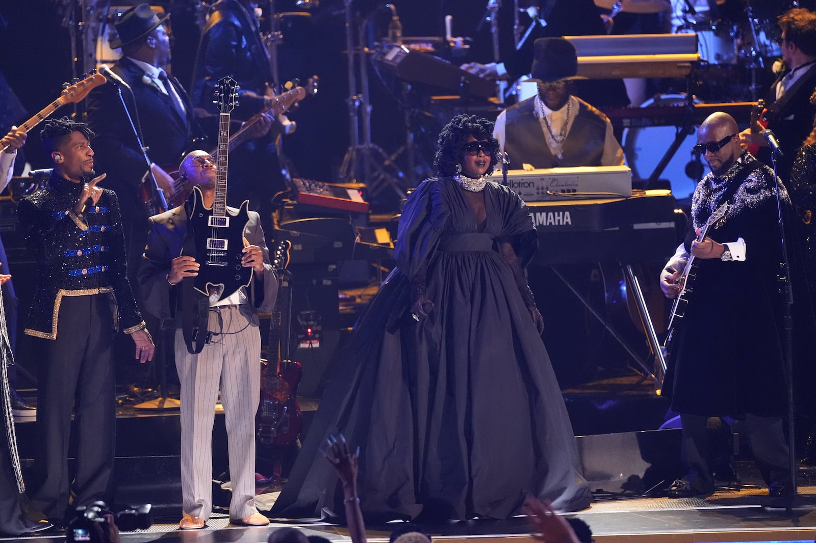 Jon Batiste, from left, Raphael Saadiq, Lauryn Hill, and Wyclef Jean perform an in memoriam tribute during the 68th annual Grammy Awards on Sunday, Feb. 1, 2026, in Los Angeles. (AP Photo/Chris Pizzello)
