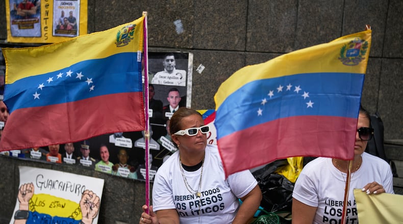People who consider their detained family members to be political prisoners protest for their releases outside the United Nations office in Caracas, Venezuela, Wednesday Feb. 18, 2026. (AP Photo/Ariana Cubillos)